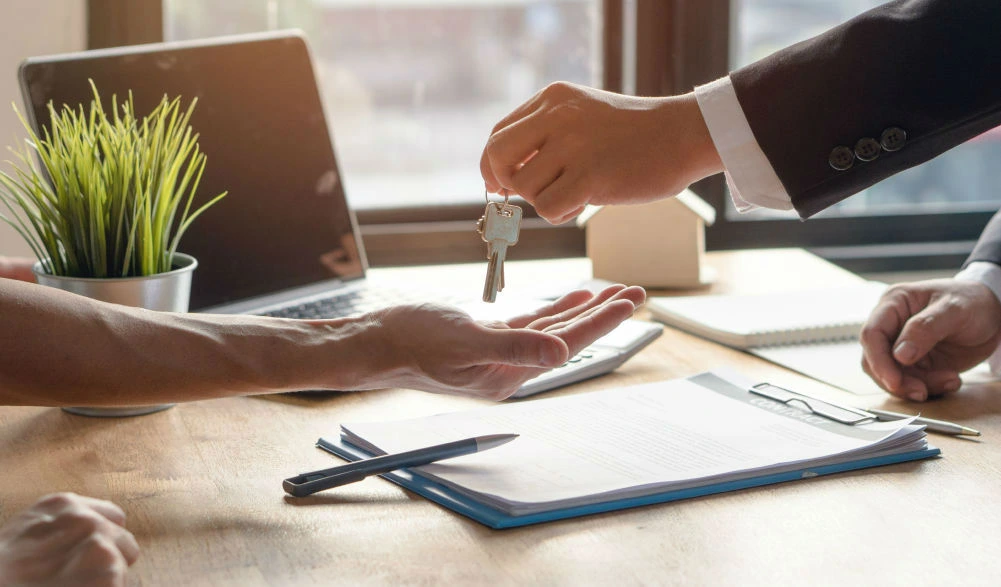 person handing house keys over